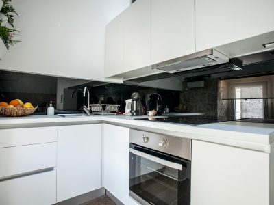 Full kitchen in Vivid flat with lofted bedroom